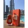 Intense peach EDP 50 ml — товар в стилизованной композиции; очень крупный план; на открытом воздухе; самый близкий кадр