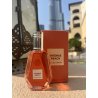 Intense peach EDP 50 ml — товар в стилизованной композиции; очень крупный план; на открытом воздухе; самый широкий кадр