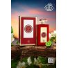 Fragrance World Queen of Red EDP 100 ml — товар в стилизованной композиции; очень крупный план; среди зелени; самый широкий кадр