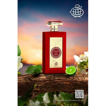 Fragrance World Queen of Red EDP 100 ml — товар в стилизованной композиции; очень крупный план; среди зелени; самый близкий кадр