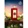 Fragrance World Queen of Red EDP 100 ml — товар в стилизованной композиции; очень крупный план; среди зелени; самый близкий кадр