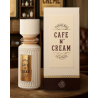Fragrance World Cafe N' Cream EDP 100 ml — produkt i en stiliseret opstilling; meget tæt nærbillede; på en træoverflade