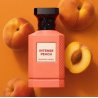 Fragrance World Intense Peach EDP 80 ml — товар и упаковка; очень крупный план; с ингредиентами аромата; самый близкий кадр