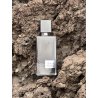 Black Afgano EDP 60 ml — товар в стилизованной композиции; очень крупный план; на каменной поверхности; средний план