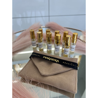 MARABIKA Sample set No. 1 EDP 3 ml × 10 — product in a styled setting; tight close-up; on a wooden surface; closest framing