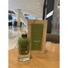 Lattafa Perfume Pistachio Musk EDP 100 ml — produkts stilizētā vidē; ļoti tuvs plāns; uz koka virsmas; vidējs kadrējums