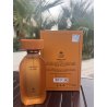 Amber D'OR EDP 100 ml — product in een gestileerde setting; zeer nabije close-up; tussen groen; meest nabije kadrering