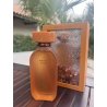 Amber D'OR EDP 100 ml — product in een gestileerde setting; zeer nabije close-up; tussen groen; ruimste kadrering