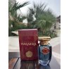 Lattafa Perfume Al QUBAH EDP 100 ml — товар в стилизованной композиции; очень крупный план; среди зелени; самый близкий кадр