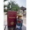 Lattafa Perfume Al QUBAH EDP 100 ml — товар в стилизованной композиции; очень крупный план; среди зелени; самый широкий кадр